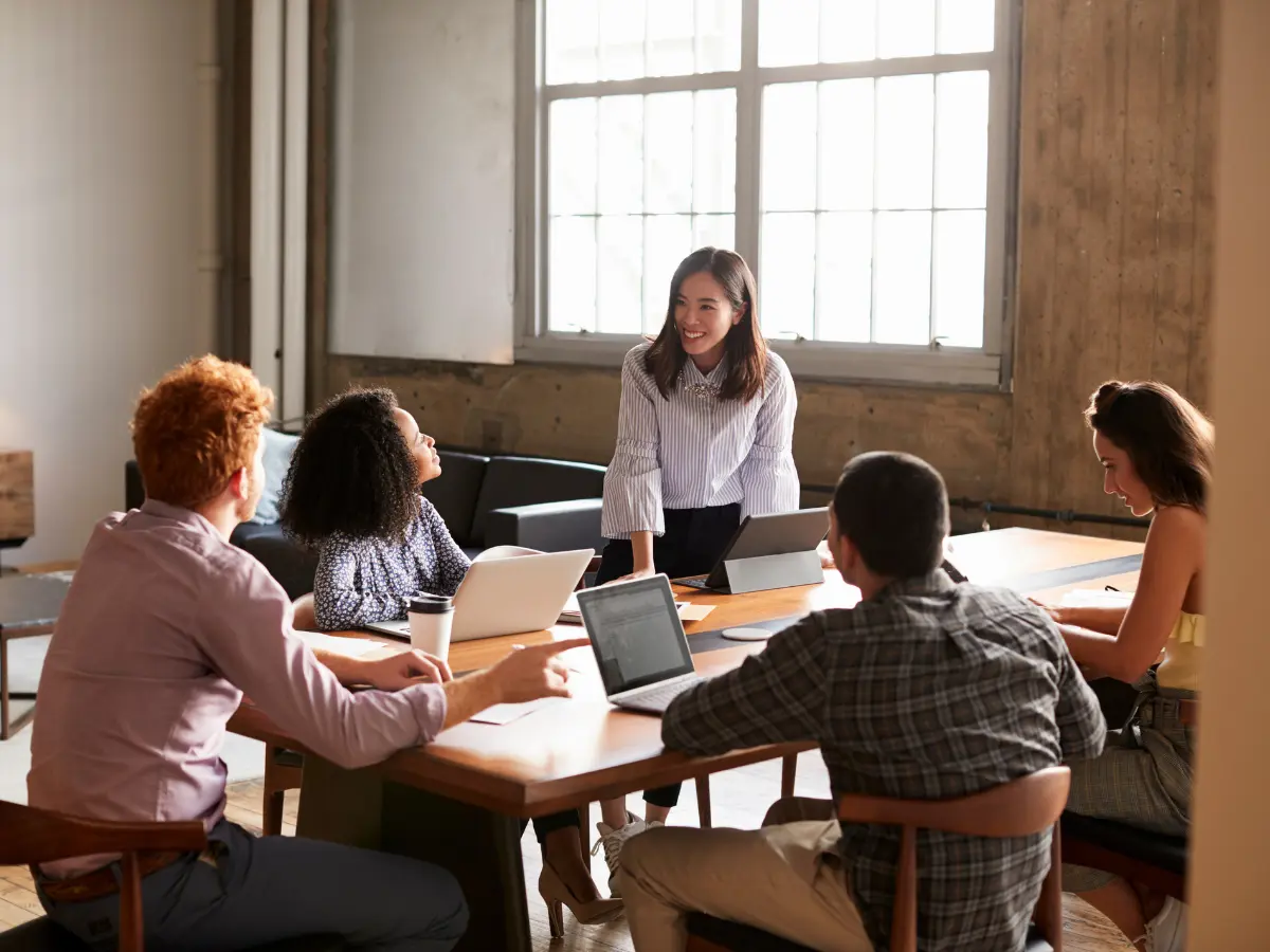 MBA student leading a discussion in a professional setting.