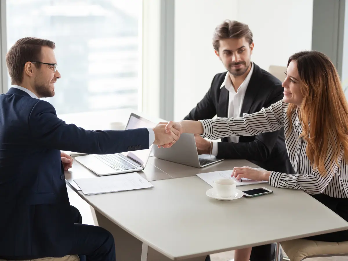 MBA student shaking another professional's hands.